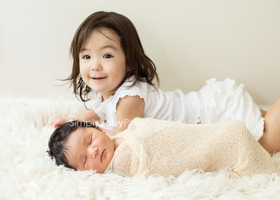 Big sister with newborn sister
